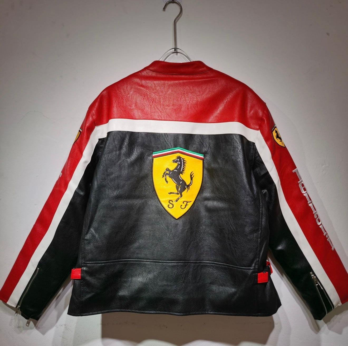 Iconic Ferrari Motorsport Leather
Jacket - Black Base with Red Accents & Major Sponsor Patches